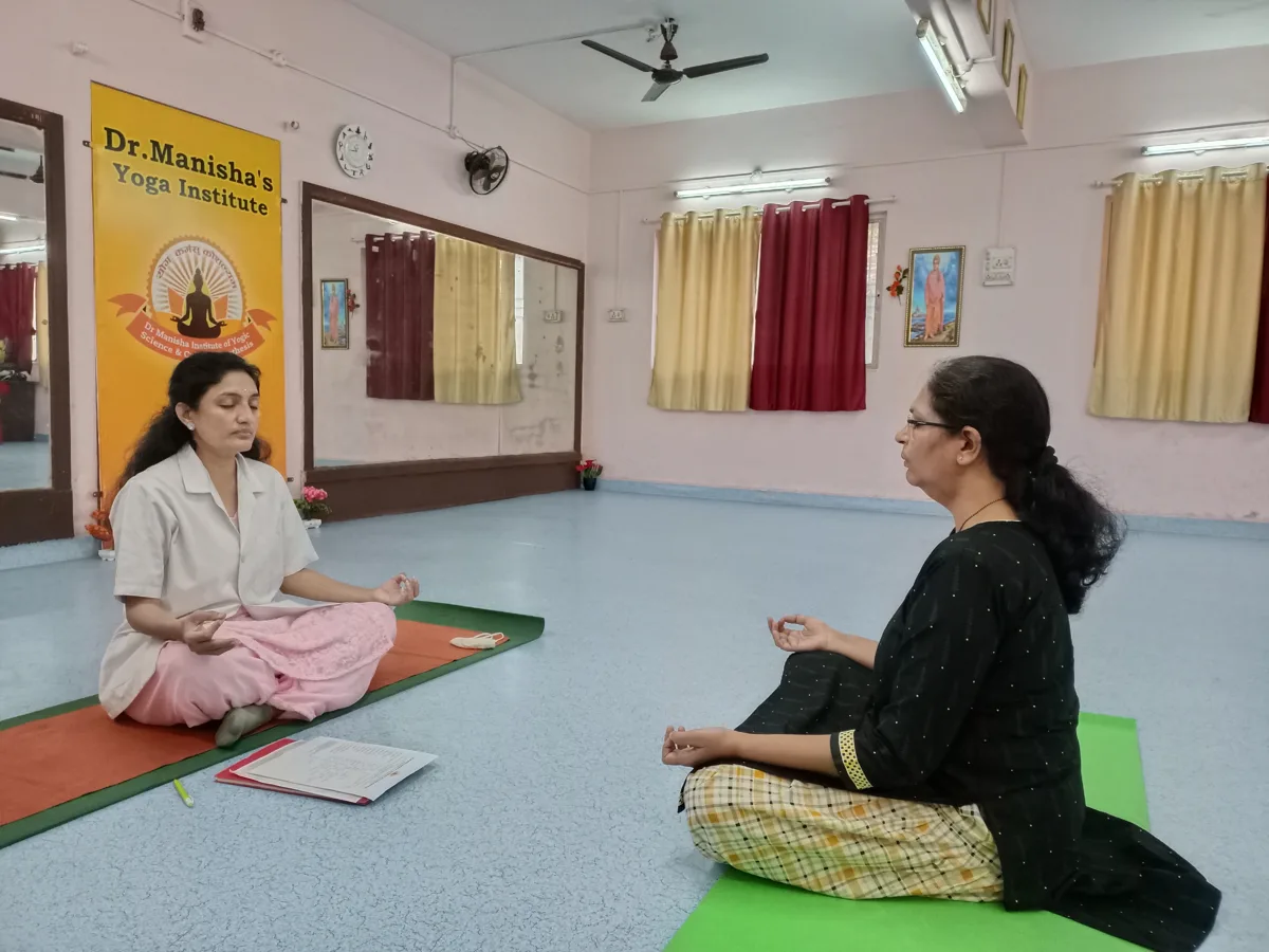 Dr. Manisha and a student sharing a seated practice at the institute