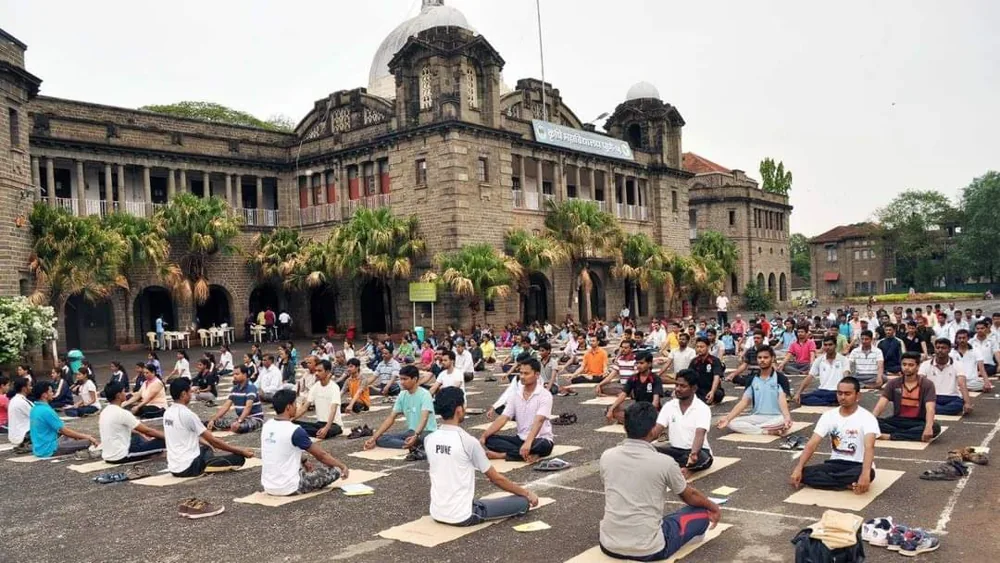 A community practising yoga together outdoors